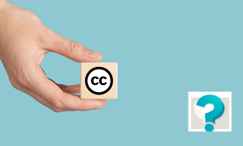 imatge d'una mà amb un dau amb l'icona de Creative Commons