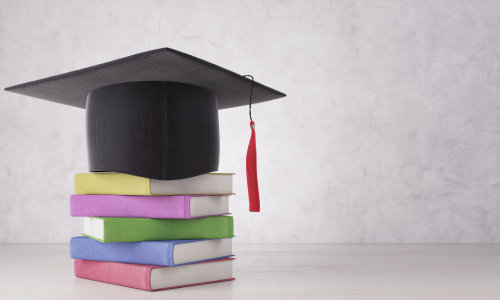 image of a cap on a column of books